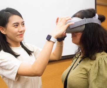 Two staff memebers using a VR device