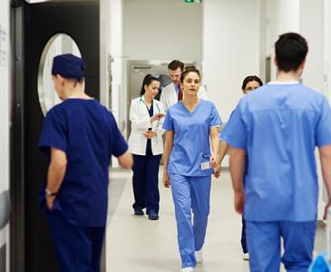 Medical staff wearing scrubs in a hospital corridor