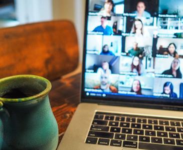 Coffee mug next to laptop Teams meeting