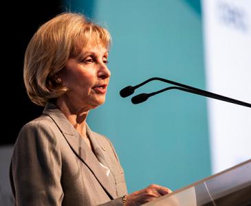 Jillian Segal AO standing at a lectern delivering a speech