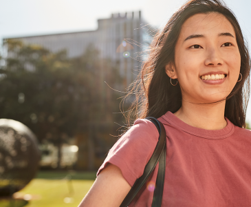 A student standing by Globe Lawn