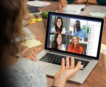 A person holding an online meeting on their laptop