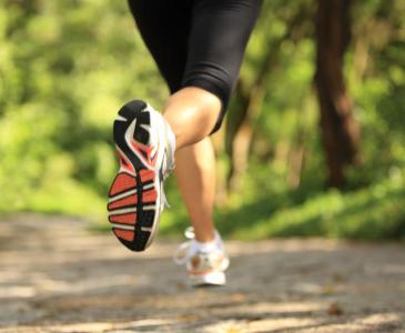 Woman jogging on forest track