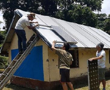 students installing solar panels in Vanuatu