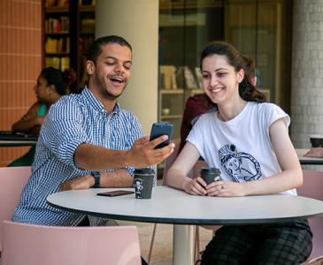 UNSW students enjoying the Uni-verse app at UNSW Bookshop