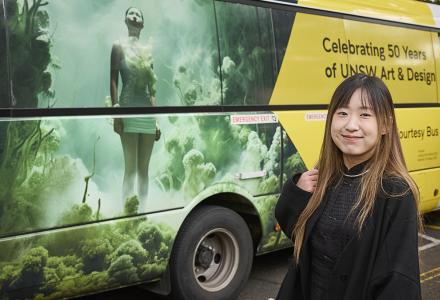 PhD candidate Jiaying Qian with the bus artwork she designed