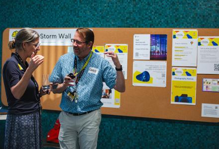Two staff members talking in the Teaching Commons