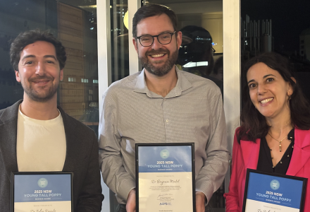 Three people holding Young Tall Poppy certificates