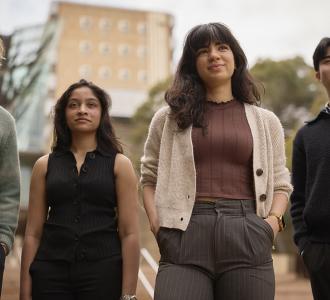 Four students looking into the distance
