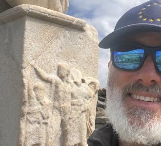 Adam Fish with a statue behind him
