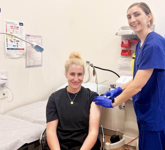 A member of staff receiving a vaccination