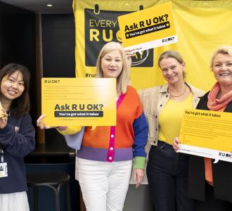 Four women holding R U Ok? Day signs