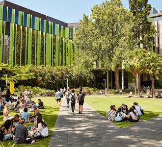 View of people sitting on lawn at UNSW campus