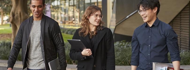 Three students walking and talking