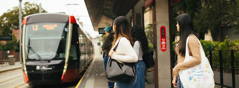 People at a light rail stop
