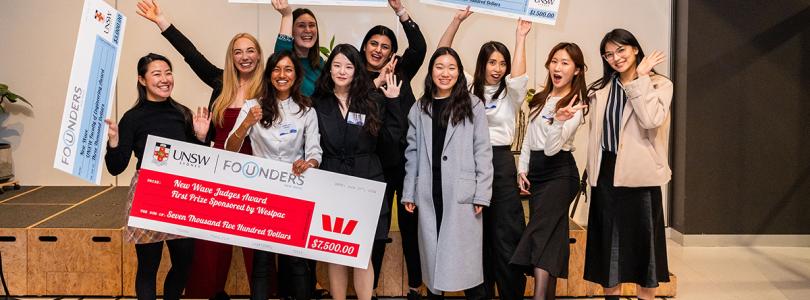 A group of women posing with a large cheque
